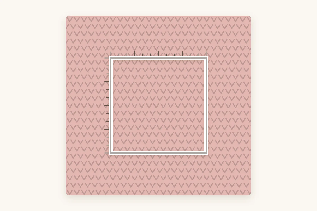 A crochet swatch with a square measuring window marked over its center for counting stitches and rows
