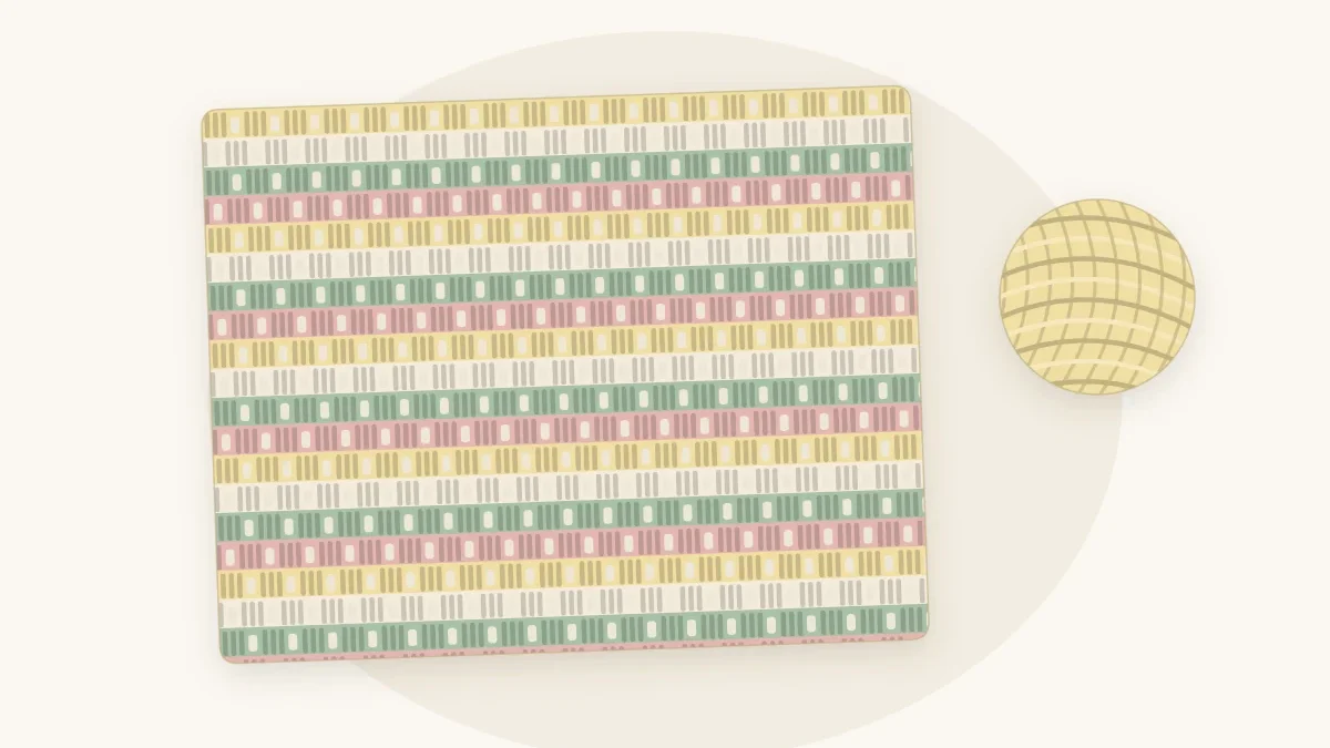 A granny stripe crochet baby blanket with narrow horizontal rows of stitch clusters in butter, cream, sage and dusty rose