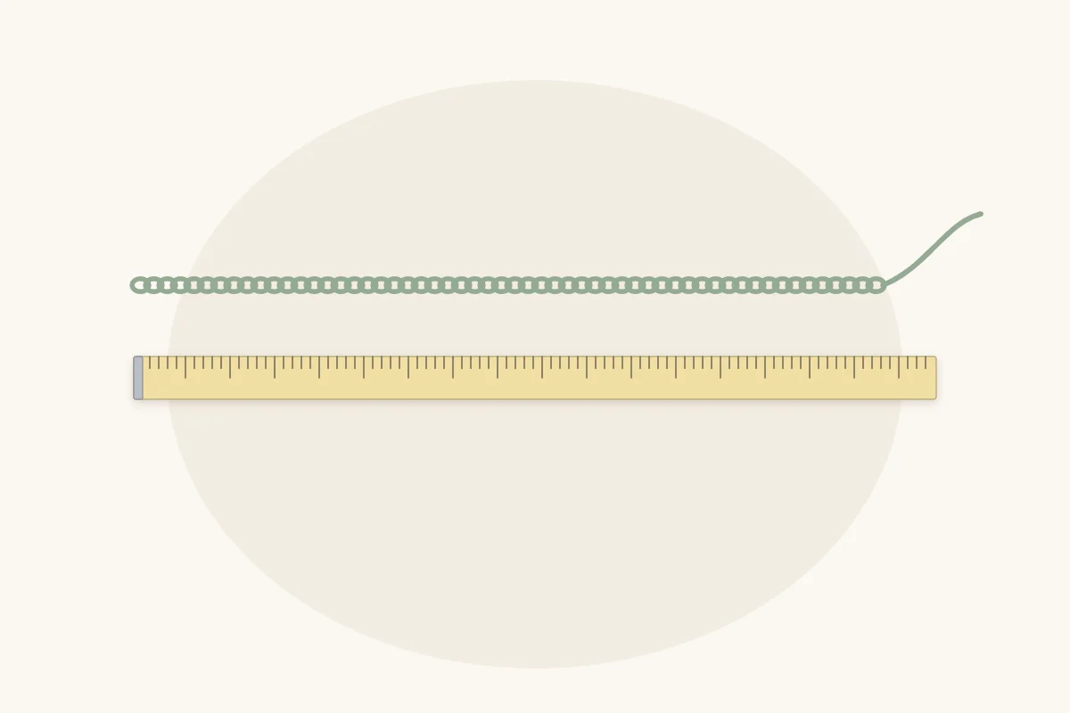 A straight foundation chain lying above a tape measure for comparing chain length with the planned blanket width