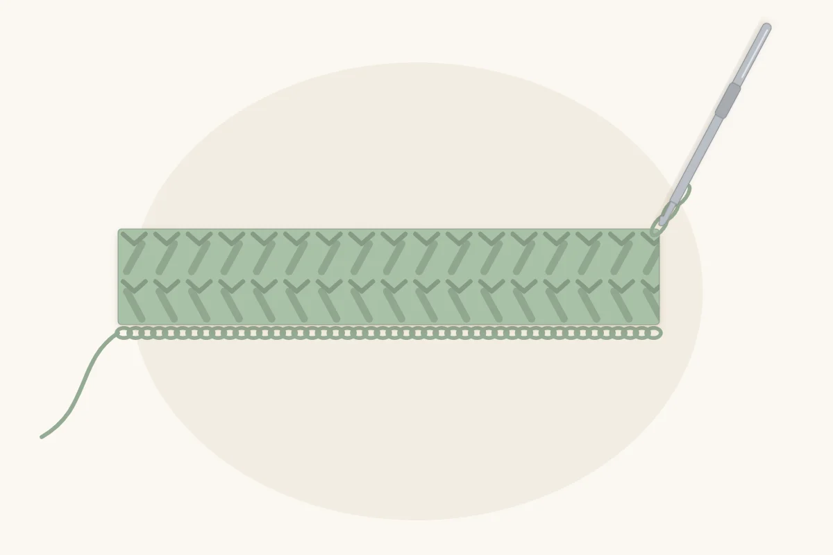 A foundation chain with the first two rows of stitches worked into it, hook still in the last loop