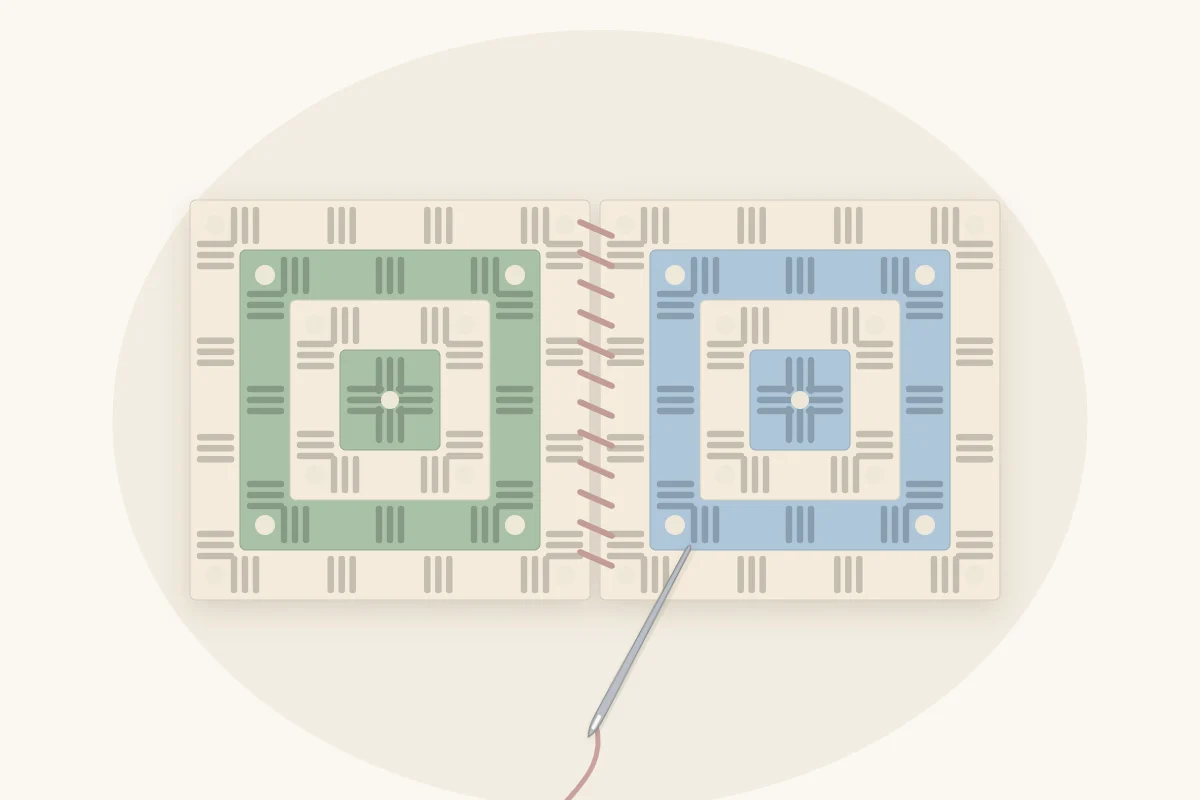 Two granny squares held edge to edge and sewn together with a yarn needle using whip stitch