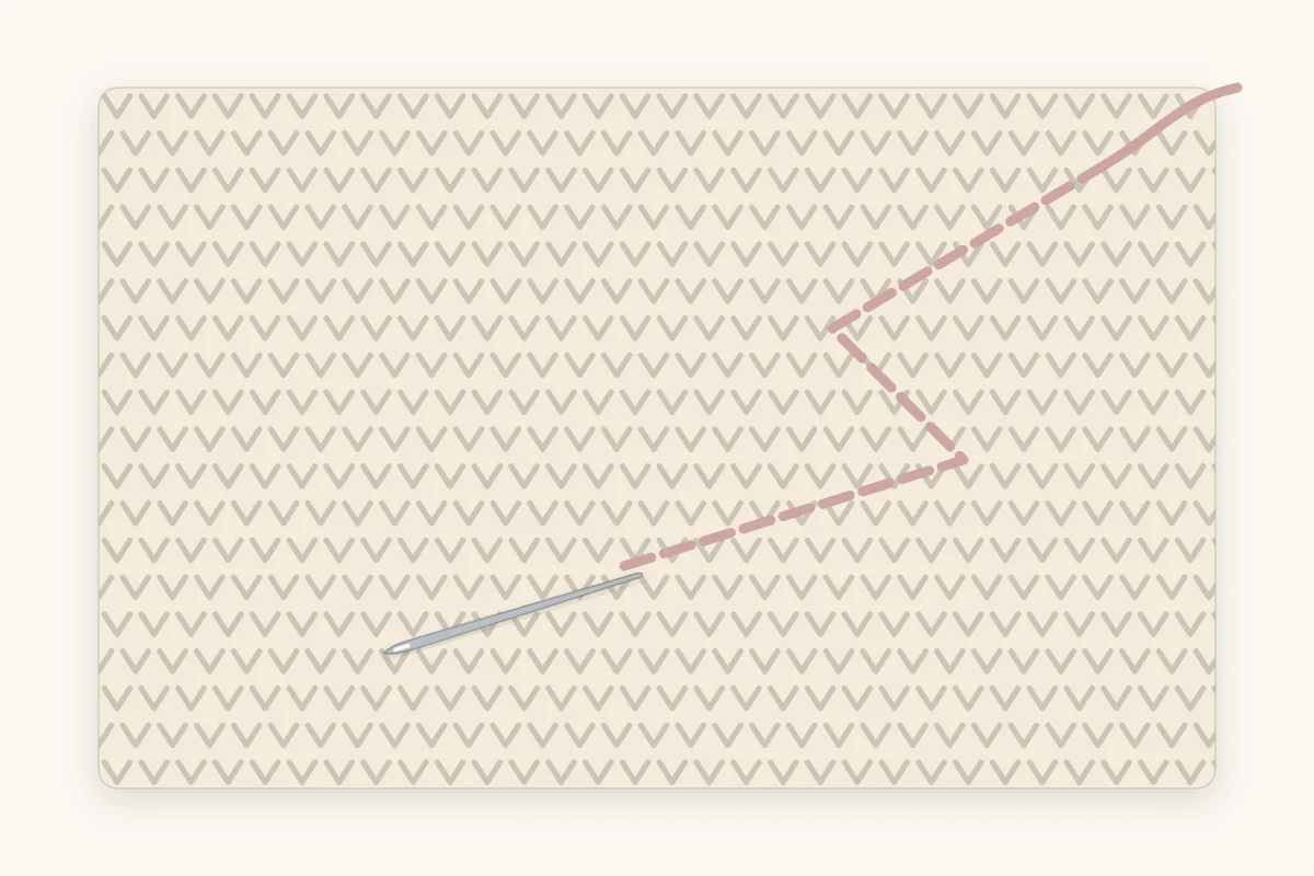 The back of crochet fabric with a yarn needle drawing a tail through the stitches along a zigzag path