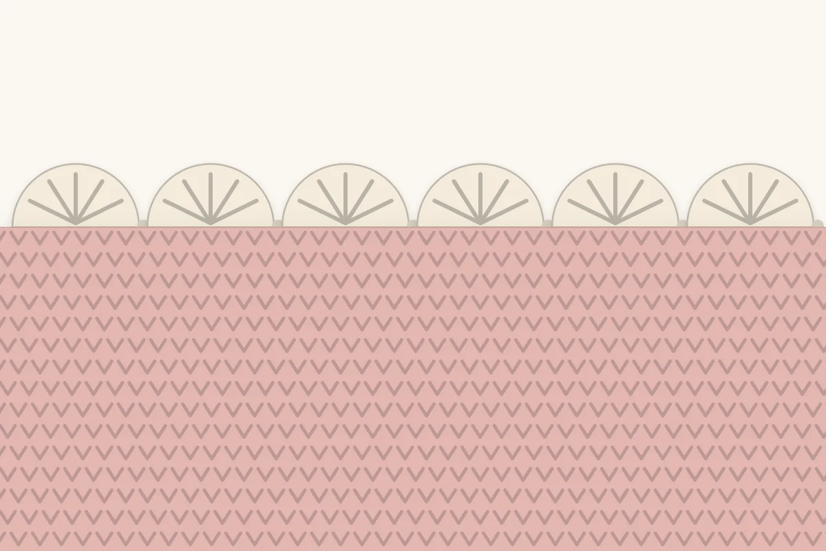 Close-up of a scalloped crochet edging showing fan-shaped shells anchored between single stitches along the blanket edge